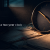 Navy wall clock casting long shadows over a desk covered in medical records and a court calendar with dates circled in red